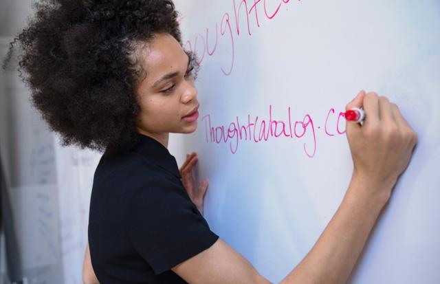woman writing on a whiteboard