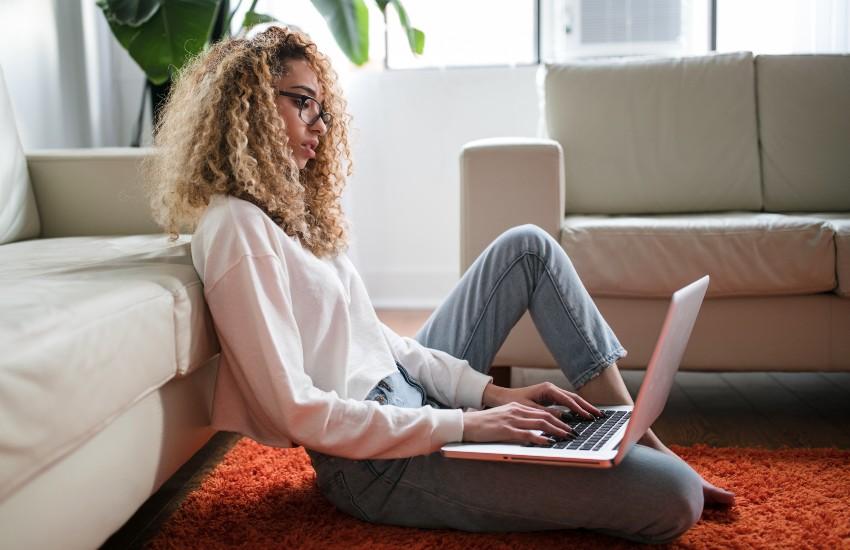 woman sitting on the floor with her laptop