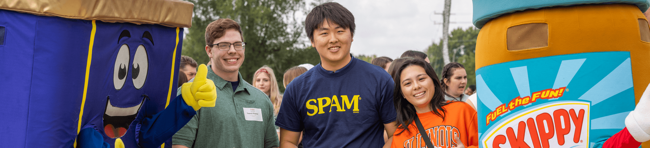 people posing with various hormel foods like skippy and spam mascots