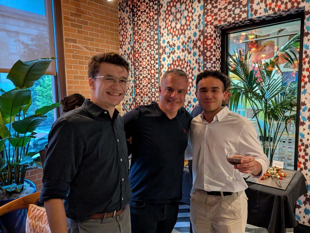 employees posing for a group shot at a happy hour