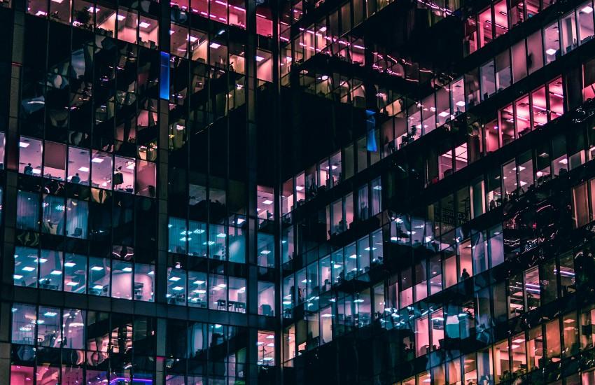 office building with lights on inside, seen from outside