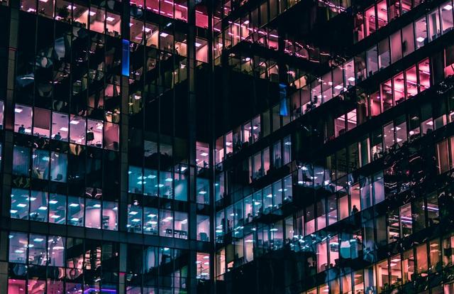 office building with lights on inside, seen from outside