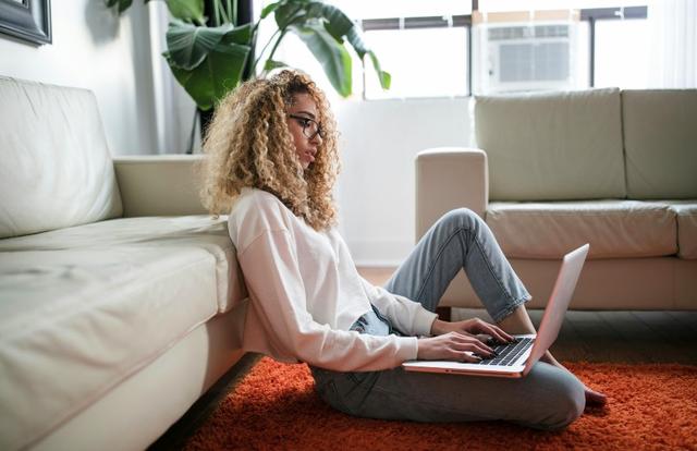 woman sitting on the floor with her laptop