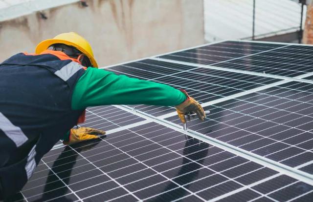 Man installing solar panels